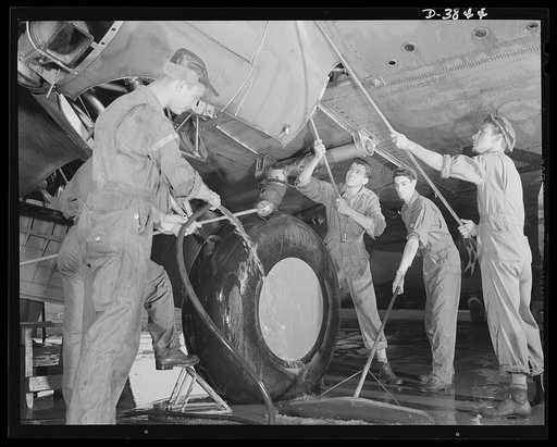 YB-17 bombardment squadron, Langley Field, Virginia. The buck privates don't get all of the dirty jobs in this man's army. A group of non-coms in a bombardment squadron at Langley Field, Virginia wash down the landing gear of a four-engine bomber