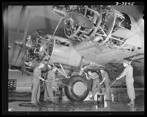YB-17 bombardment squadron, Langley Field, Virginia. The buck privates don't get all of the dirty jobs in this man's army. A group of non-coms in a bombardment squadron at Langley Field, Virginia wash down the landing gear of a four-engine bomber