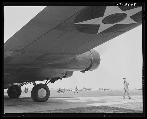 YB-17 bombardment squadron, Langley Field, Virginia. A warship of the air, a YB-17 bomber, poised for a takeoff at Langley Field, Virginia. A master sergeant of the bombardment squadron runs a practical eye over the big four-engine ship as the pilot warms up the engine