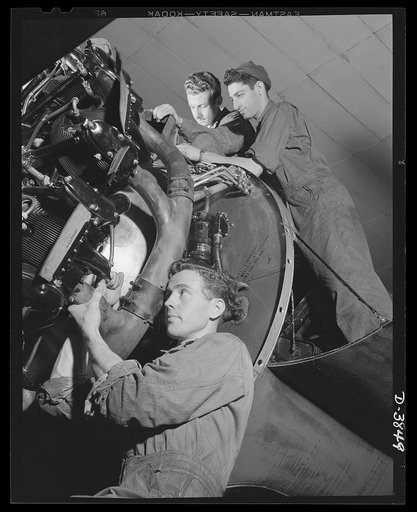 YB-17 bombardment squadron, Langley Field, Virginia. These corporals of a bombardment squadron at Langley Field, Virginia replace the exhaust pipe of a huge YB-17 bomber motor. A short time before, they had removed and inspected the pipe as part of a general engine overhaul