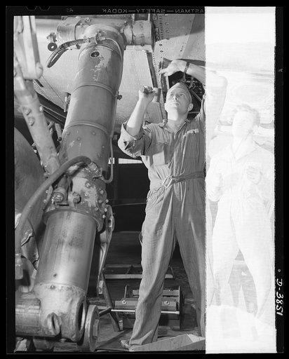 YB-17 bombardment squadron, Langley Field, Virginia. More fuel-storage space for a mighty aerial warship. A master sergeant of a bombardment squadron at Langley Field, Virginia installs gasoline tanks in the lower section of a wing of a YB-17 bomber