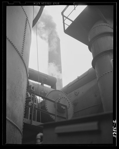 Steel production. Smoke and steel. A black furnace stove and a belching boiler house stack help swell the volume for victory. Republic, Youngstown