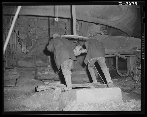 Steel Production. Workers in iron industry. Furnace men drill a tapping hole out of a blast furnace to swell the record-breaking volume of metal in a large Eastern steel plant. Republic, Youngstown