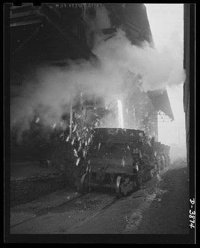 Steel production. Iron forgery scene. Molten metal running into a ladle from the tapping hole of a blast furnace at a big Eastern steel plant. Republic, Youngstown