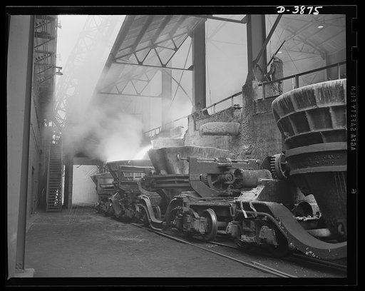 Steel production. Molten slag running from an Eastern blast furnace into a cinder ladle. The slag serves many useful purposes. Republic, Youngstown