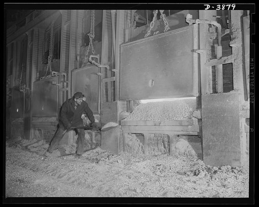 Steel production. A step in the making of steel. A workman at an Eastern steel plant banks the doors of an open hearth furnace after the charge of steel