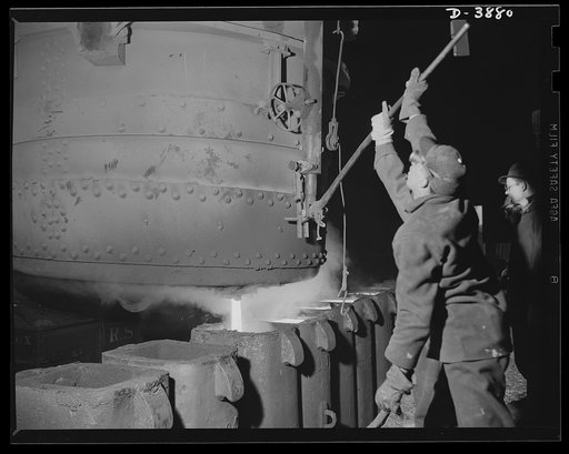 Steel production. Steel activity in war time. Molten metal is poured into large molds at an Eastern open hearth furnace. Republic, Youngstown