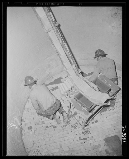Steel production. Steel workers inside a huge ladle. Many men back the steel industry's production drive. Aided by a convenient brick chute, hard hats are shown lining a steel ladle. Republic, Youngstown