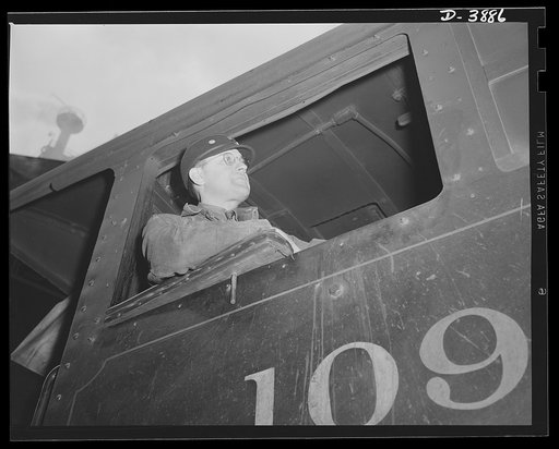Steel production. Scene in steel industry. The engineer of locomotive guides truckloads of materials at an Eastern steel plant. Republic, Youngstown