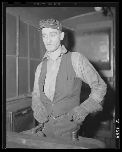 Steel production. A steel mill worker. The operator at the controls of a pushing machine is responsible for cleaning coke from the ovens of an Eastern by-product plant. Republic, Youngstown