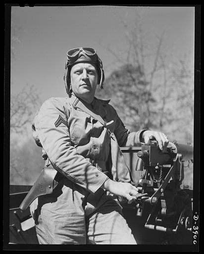 Fort Benning. Machine gunners, armored forces. Our armored forces hit hard and fast. This corporal at the breech end of .30 caliber Browning works from one of the Army's new halftrac scout cars