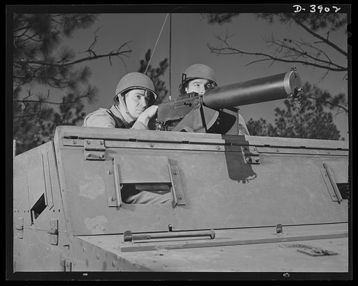 Fort Benning. Machine gunners, armored forces. Our armored forces have tremendous fire power. These machine gunners on a halftrac scout car make the .30 caliber Browning one of the most destructive of modern weapons