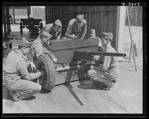 Fort Benning. Anti-tank gun crews. Crew of a 37mm anti-tank gun in training at Fort Benning, Georgia clean and adjust their weapons