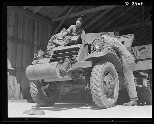 Fort Benning. Halftrac scout cars. Sodiers of the armored forces must know their machines. The crew of a halftrac scout car in training at Fort Benning, Georgia learns to handle many maintenance and emergency repair jobs