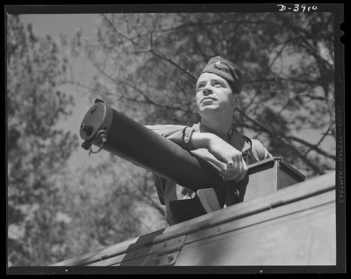 Fort Benning. Machine gunners, armored forces. Plenty of trouble for the Axis in this combination. Machine gunner of a halftrac scout car and a .30 caliber Browning