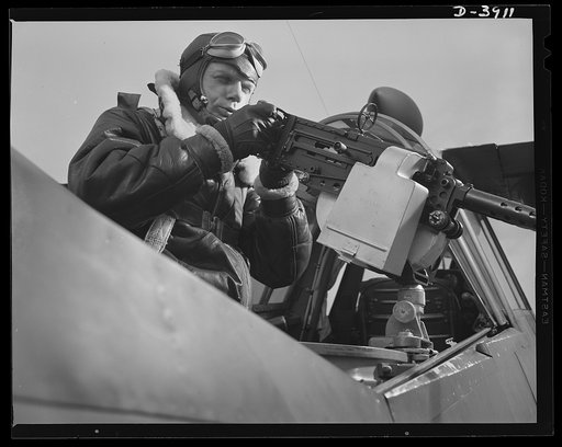 Fort Benning. Aerial machine gunners. Four aces. This crack aerial machine gunner is part of an unbeatable combination. He has a fast, accurate gun -- and the world's best in the way of plane and pilot