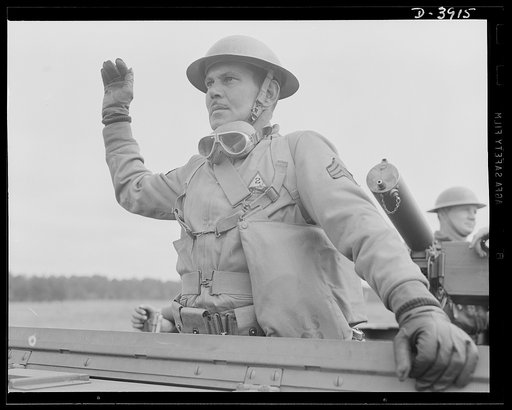 Fort Benning. Armored forces peronnel. Sergeant of the armored forces and commanding officer of a halftrac scout car. One of the capable men teaching recruits at Fort Benning, Georgia some of the good American ways of upsetting Japanese schedules