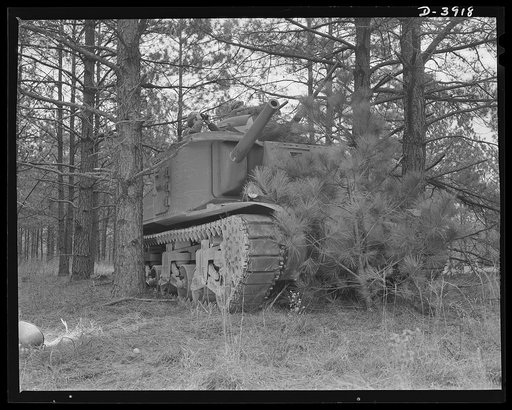 Fort Benning. Tank forces. A medium tank (M-3) partially screened by foliage near Fort Benning, Georgia. Trainees of the armored forces make observations from the turrets as part of the course from which they will graduate as smart and hardened soldiers