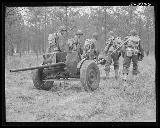 Fort Benning. Anti-tank gun crews. Manhadling a 37mm anti-tank gun into position is only one of the chores that young gun crews training at Fort Benning, Georgia take in stride