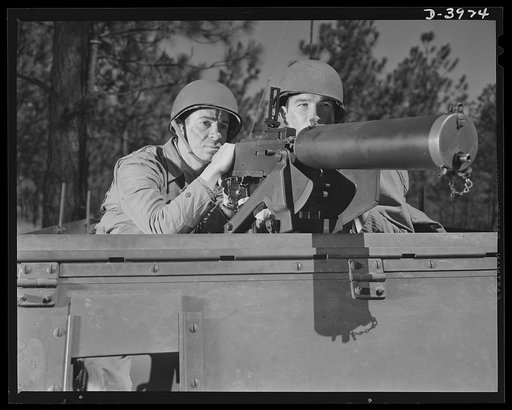 Fort Benning. Machine gunner, armored forces. Our armored forces have tremendous fire power. These gunners on a halftrac scout car make the .30 caliber Browning one of the most destructive of modern weapons