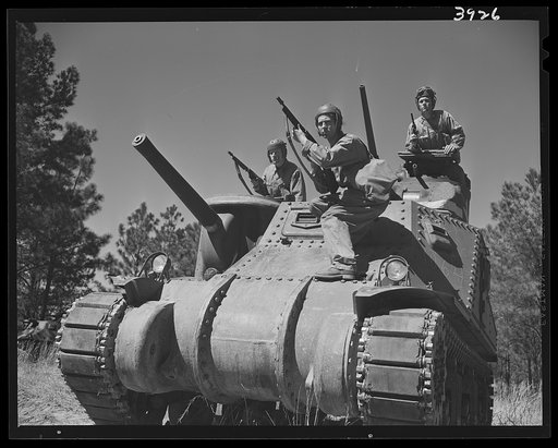 Fort Benning. Tank forces. A medium tank (M-3) bristles with cannon, anti-aircraft guns, Tommy guns and pistols as soldiers of the armored forces in training at Fort Benning, Georgia prepare for a sally