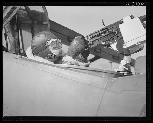 Fort Benning. Aerial machine gunners. Four aces. This crack aerial machine gunner is part of an unbeatable combination. He has a fast, accuerate gun and the world's best in the way of plane and pilot