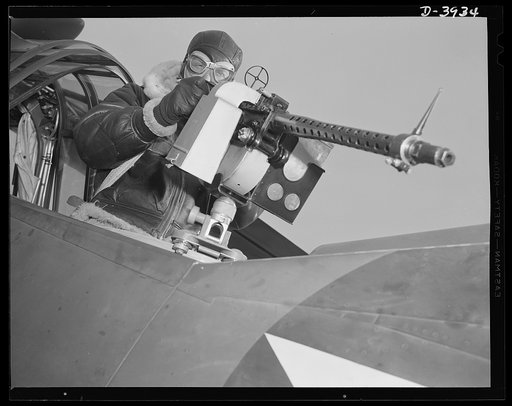 Fort Benning. Aerial machine gunners. Four aces. This crack aerial machine gunner is part of the unbeatable combination. He has a fast, accurate gun and the world's best in the way of plane and pilot