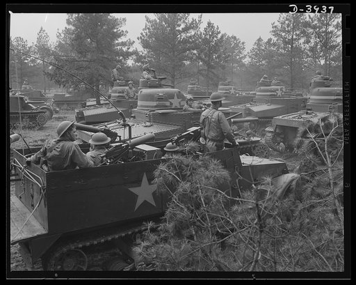 Fort Benning. Armored forces, Georgia. The irresistable roll of America's mighty new army is already shaping world events. Medium tanks (M-3) flanked by halftrac scout cars are put through their paces by trainees of the armored forces at Fort Benning, Georgia