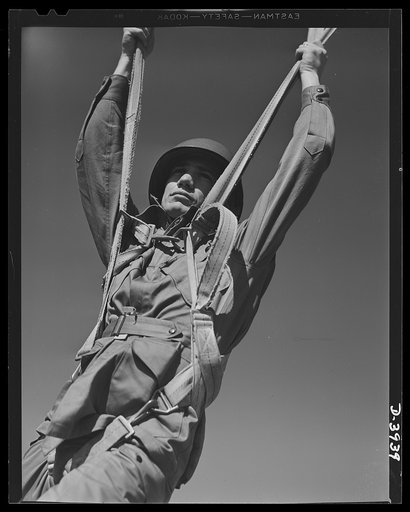 Fort Benning. Parachute troops. Ready to make port. A student paratrooper at Fort Benning, Georgia who bailed out of a plane a few minutes ago is about ready to take the ground and perform the little chore of getting his chute under control