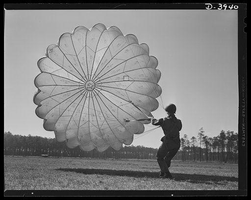 Fort Benning. Parachute troops. Picture of a man doing a good job. He's one of Uncle Sam's student paratroopers at Fort Benning, Georgia, but the way he's getting his chute under control would do credit to an old-timer. A few minutes ago this man bailed out of a high-speed plane at a point calculate