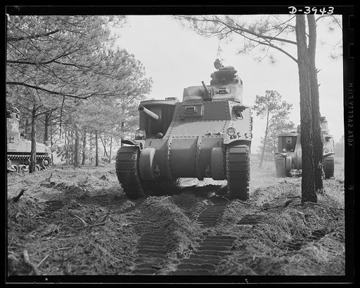 Fort Benning. Tank forces. A lot of headaches for the Axis are packed in this combination of good American soldier and good American equipment. A medium (M-3) tank and a trainee of the armored forces completing the course at Fort Benning, Georgia
