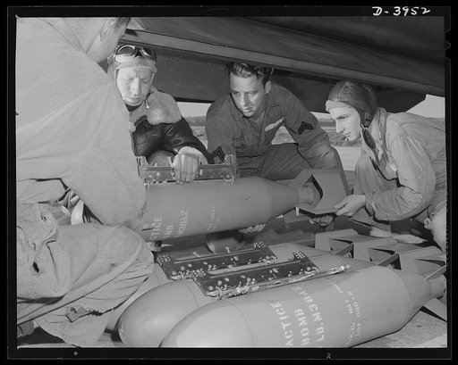 Fort Benning. Loading planes. Axis, beware! Bombardiers in training at Fort Benning, Georgia use practice bombs to learn the routine of loading a light bombing plane