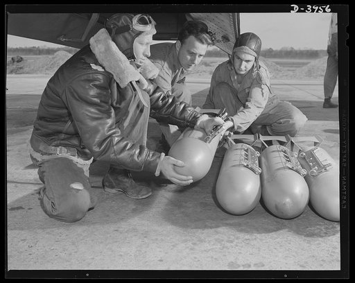 Axis, beware! Bombardiers in training at Fort Benning, Gerogia use practice bombs to learn the routine of loading a light bombing plane