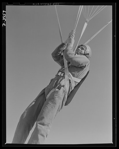Fort Benning. Parachute troops. Ready to make port. Student paratrooper at Fort Benning, Georgia, who bailed out of a plane a few minutes ago, is about ready to take the ground and perform the little chore of getting his chute under control