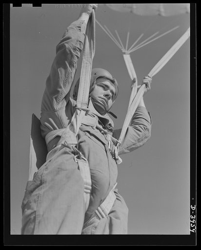 Fort Benning. Parachute troops. Ready to make port. A student paratrooper at Fort Benning, Georgia who bailed out of a plane a few minutes ago is about ready to take the ground and perform the little chore of getting his chute under control