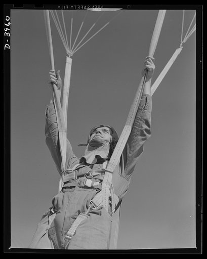 Fort Benning. Parachute troops. Ready to make port. A student paratrooper at Fort Benning, Georgia who bailed out of a plane a few minutes ago is about ready to take the ground and perform the little chore of getting his chute under control