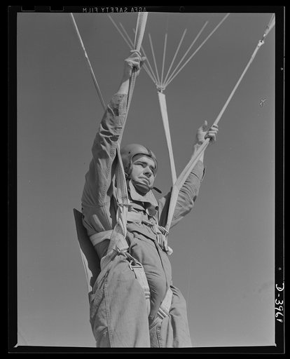 Fort Benning. Parachute troops. Ready to make port. A student paratrooper at Fort Benning, Georgia who bailed out of a plane a few minutes ago is about ready to take the ground and perform the little chore of getting his chute under control