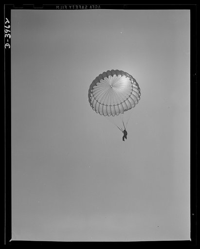 Fort Benning. Parachute troops. Here he comes. A student paratrooper at Fort Benning, Georgia has bailed out of a plane at just the point he figures will let him land at his objective. Just wait a while. He'll be seeing you