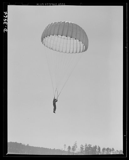 Fort Benning. Parachute troops. Good work! A student paratrooper at Fort Benning, Georgia is about to land in a big, clear space and he's all set to take the ground in the most approved paratrooper style