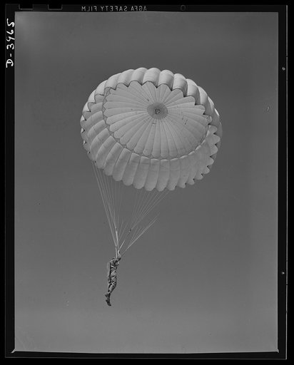 Fort Benning. Parachute troops. Look at that boy come riding a chute like an oldtimer. A student paratrooper at Fort Benning, Georgia has wind currents to think about, and he has his mind on the spot where he wants to land. He's learning to make the kind of landfall he wants