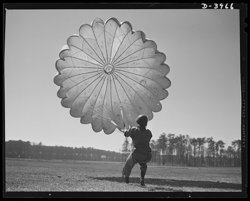 Fort Benning. Parachute troops. Picture of a man doing a good job. He's one of Uncle Sam's student paratroopers at Fort Benning, Georgia, but the way he's getting his chute under control would be credit to an oldtimer. A few minutes ago this man bailed out of a high-speed plane at a point calculated
