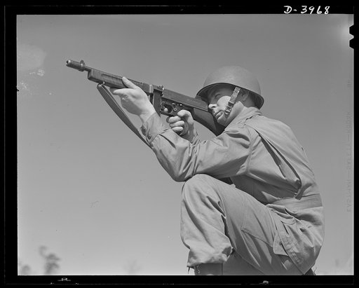 Fort Benning. Tommy gunners, parachute troops. An American paratrooper and his Tommy gun go into action as soon as they reach the ground