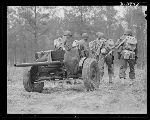 Fort Benning. Anti-tank gun crews. Manhandling a 37mm anti-tank gun into position is only one of the chores that young gun crews training at Fort Benning, Georgia take in stride
