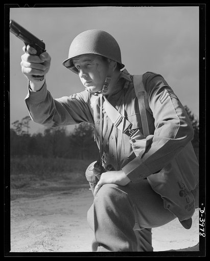 Fort Benning. Anti-tank gun crews. He's good with any kind of gun. This infantryman, finishing training at Fort Benning, Georgia, belongs to the crew of a 37mm anti-tank gun