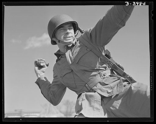Pineapples for Hitler. A young paratrooper, finishing his training at Fort Benning, Georgia, practices for perfect form in the ticklish art of grenade throwing