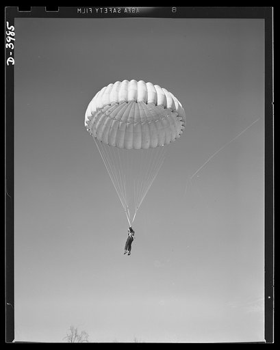 Fort Benning. Parachute troops. Look at that boy come, riding a chute like an oldtimer. A student paratrooper at Fort Benning, Georgia has wind currents to think about, and he has his mind on the spot where he wnats to land. He's learning to make the kind of a landfall he wants