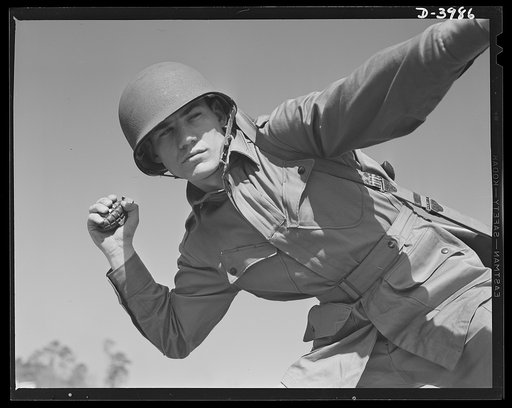 Pineapples for Hitler. A young paratrooper, finishing his training at Fort Benning, Georgia, practices for perfect form in the ticklish art of grenade throwing