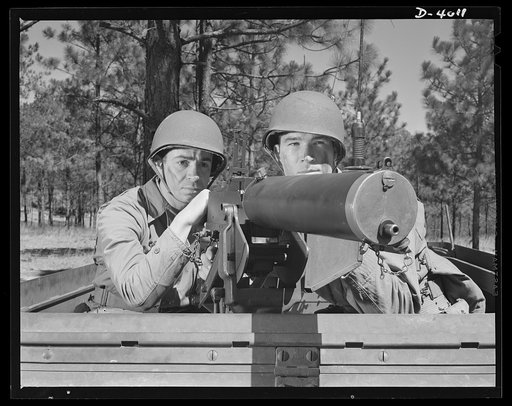 Fort Benning. Machine gunners, armored forces.  Our armored forces have tremendous fire power. These machine gunners on a halftrac scout car make the .30 caliber Browning one of the most destructive of modern weapons