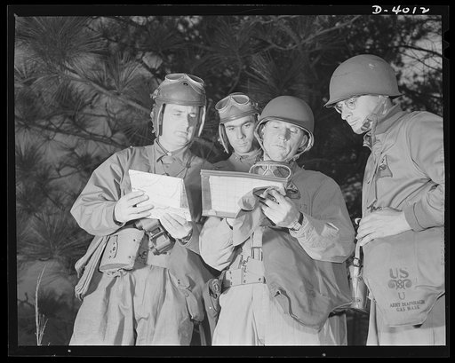 Fort Benning. Armored forces personnel. Council of the powers. A group of armored forces officers work out a tactical problem and map a course of action that will broaden the training program at Fort Benning, Georgia