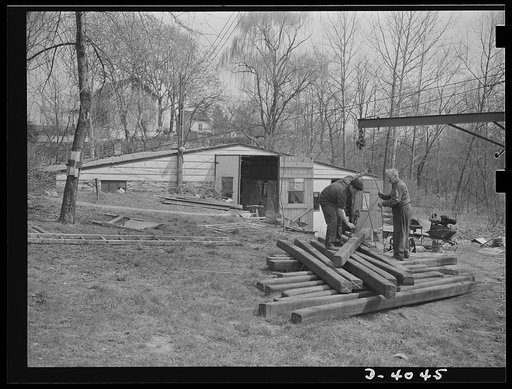 Dr. Bair. Scientist contributes brawn as well as brain to the war production drive. Dr. Bair, holder of eleven college degrees and sixty U.S. patents, helps his son transfer steel billets to the power saws in his small machine shop